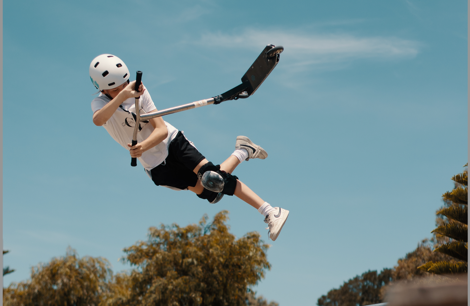 Scooter rider doing big air scooter trick