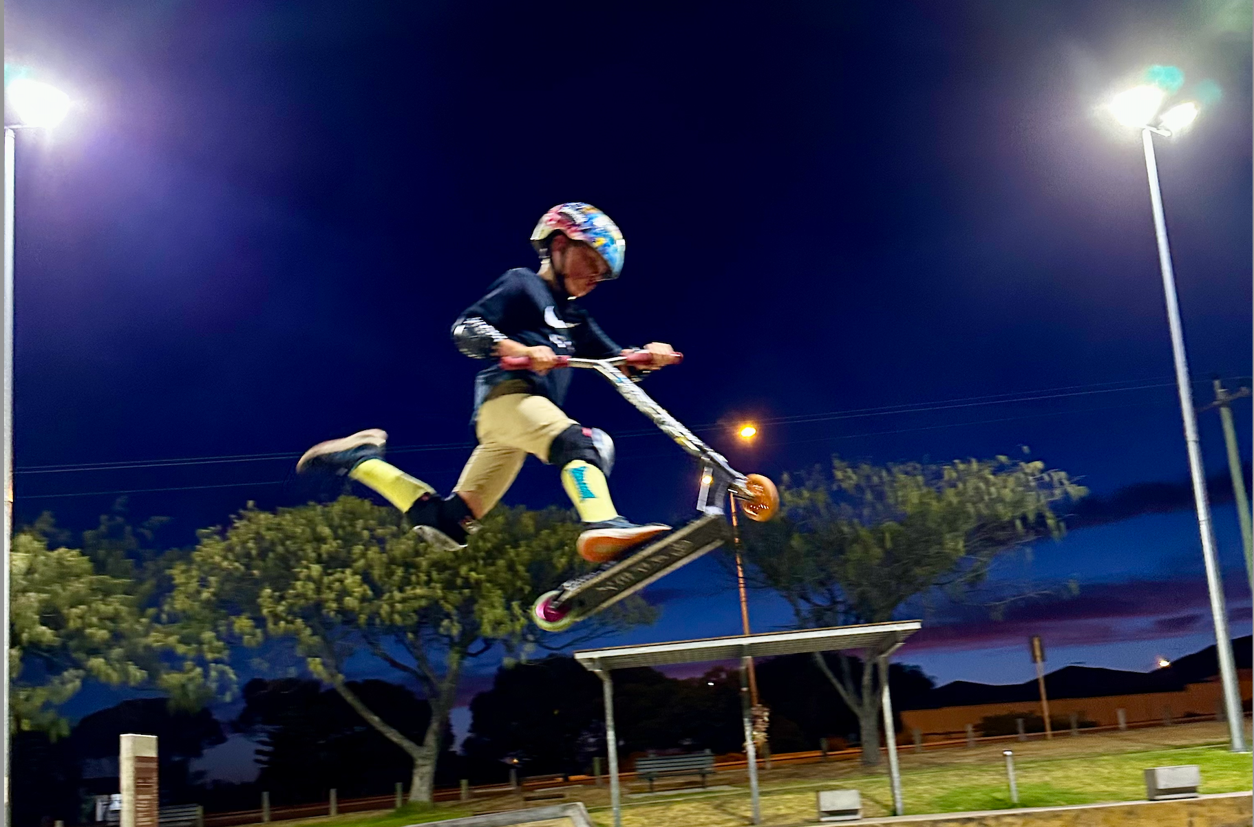 Young scooter rider learning scooter trick