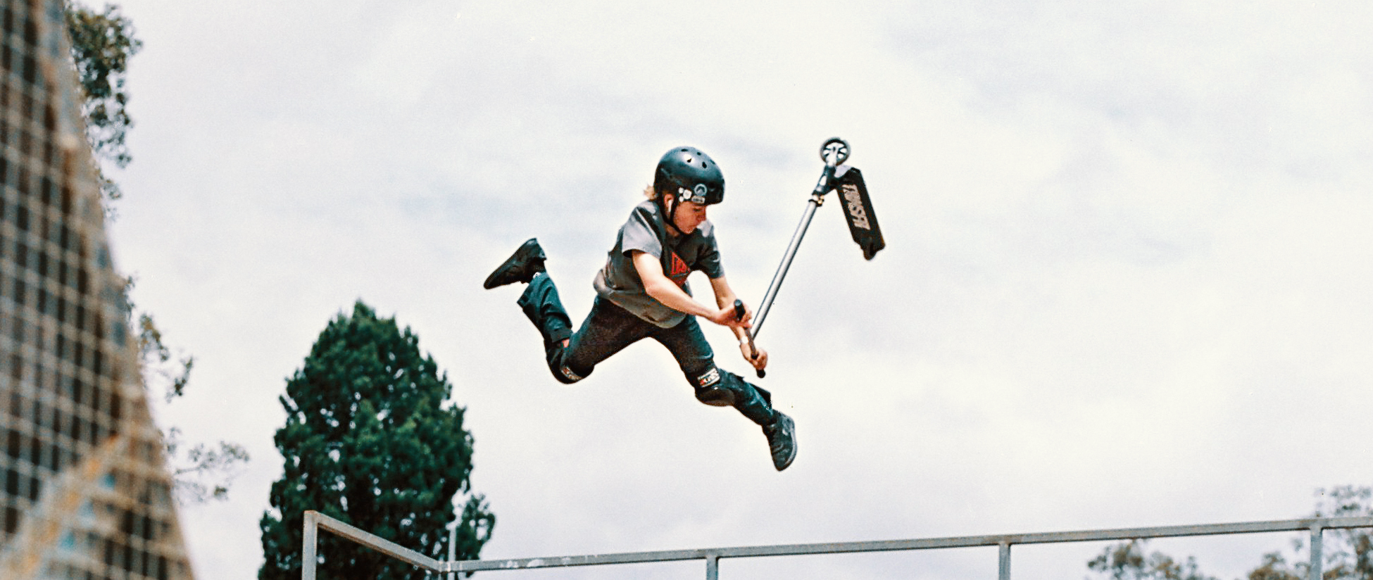 Millar Hammond, scooter rider, doing scooter trick on half pipe